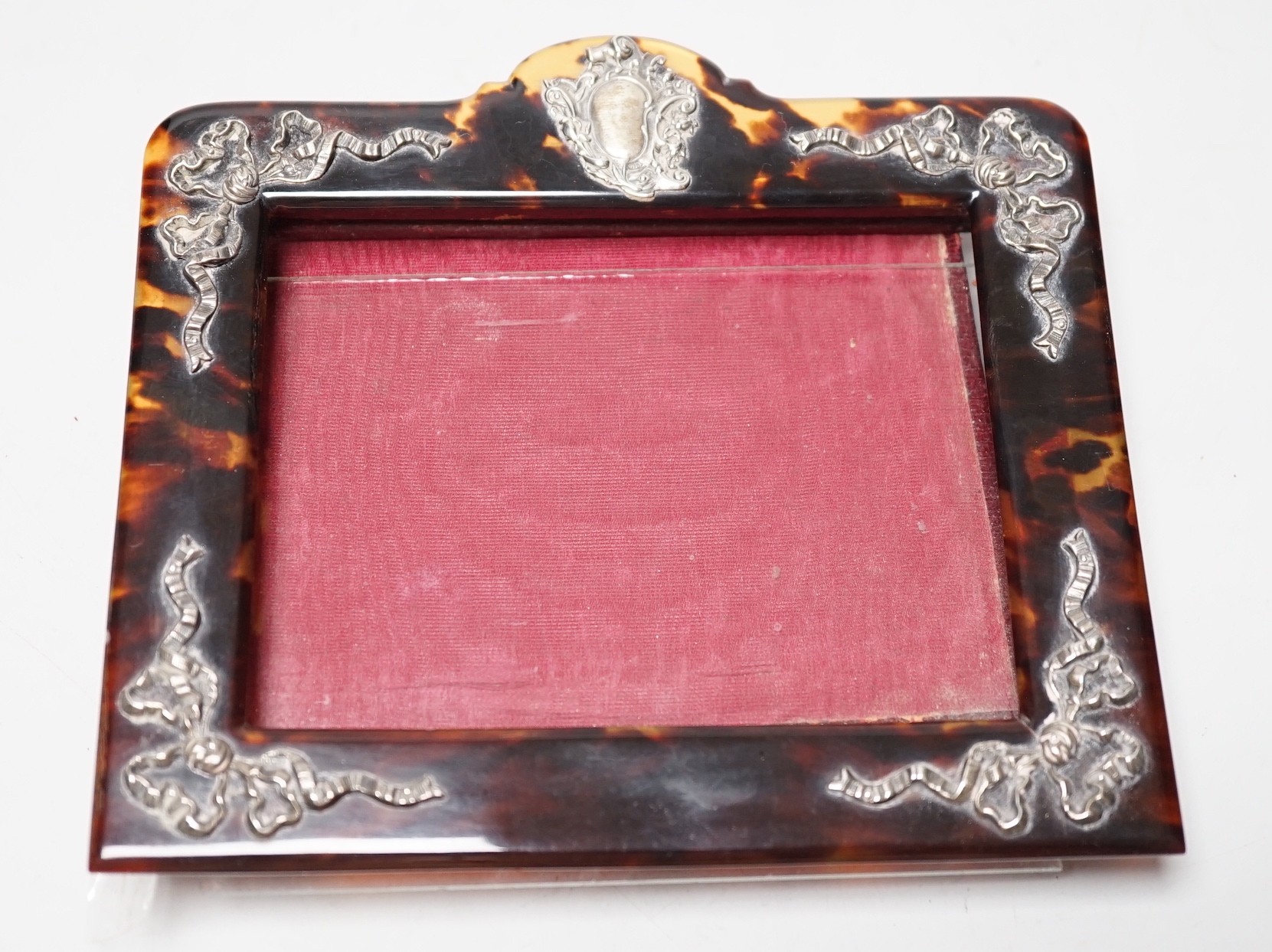 An Edwardian silver mounted tortoiseshell photograph frame, import marks for London, 1909, width 15.9cm (a.f.).